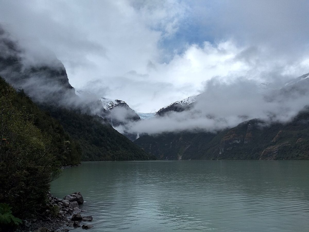 The Queulat Hanging Glacier (Ventisquero Colgante) spilling waterfalls into a turquoise lagoon in Parque Nacional Queulat