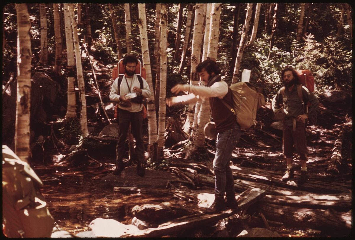 A hiking backpack and trekking poles on a mountain