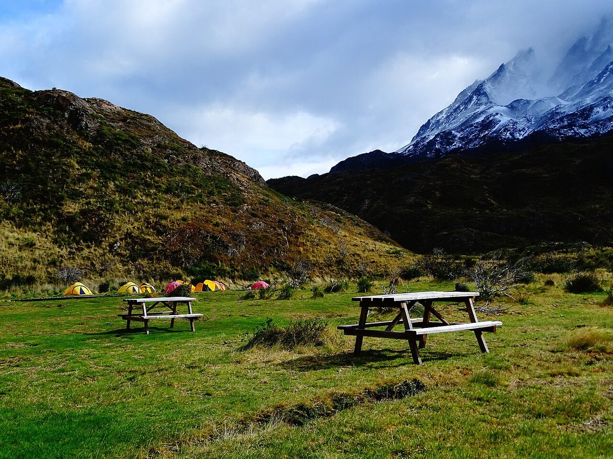 A Patagonian campsite with tents pitched on grass, the cheapest way to sleep near the trailheads