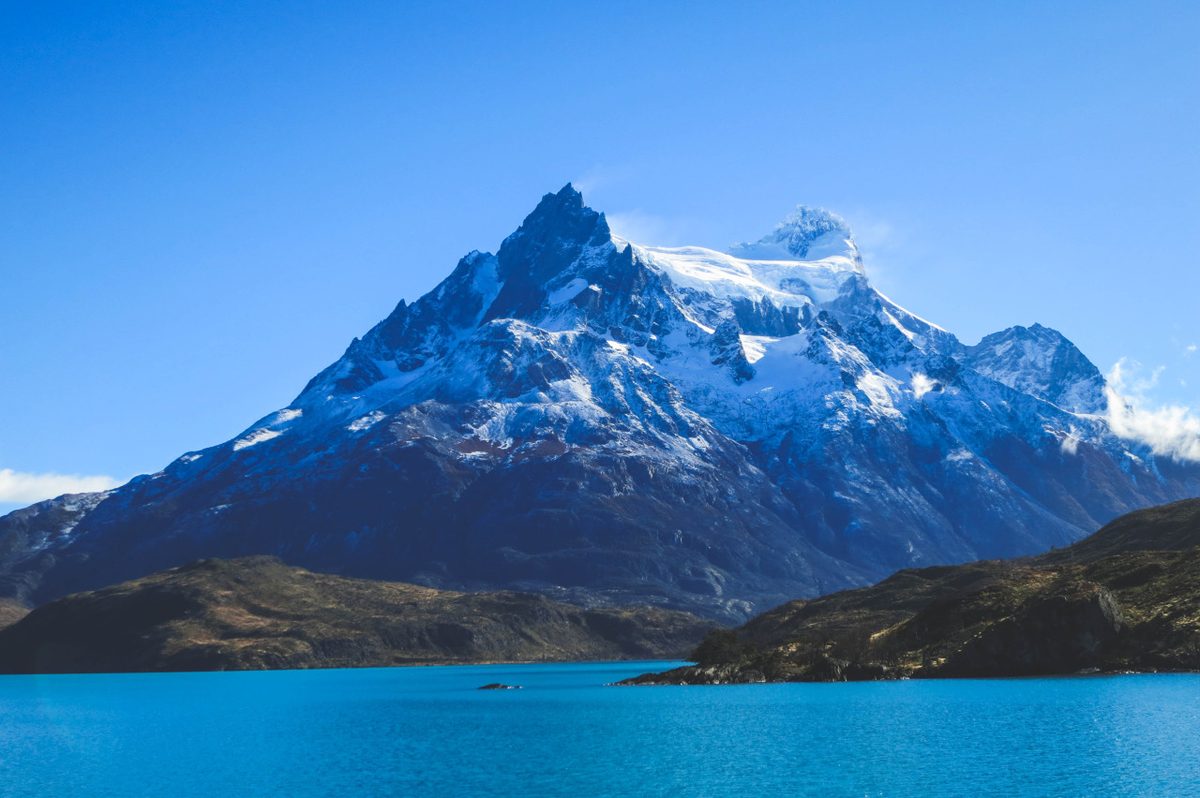 Cerro Paine Grande above the Vertice refugio sector in Torres del Paine, where the bedding tier you booked decides whether you carry a sleeping bag