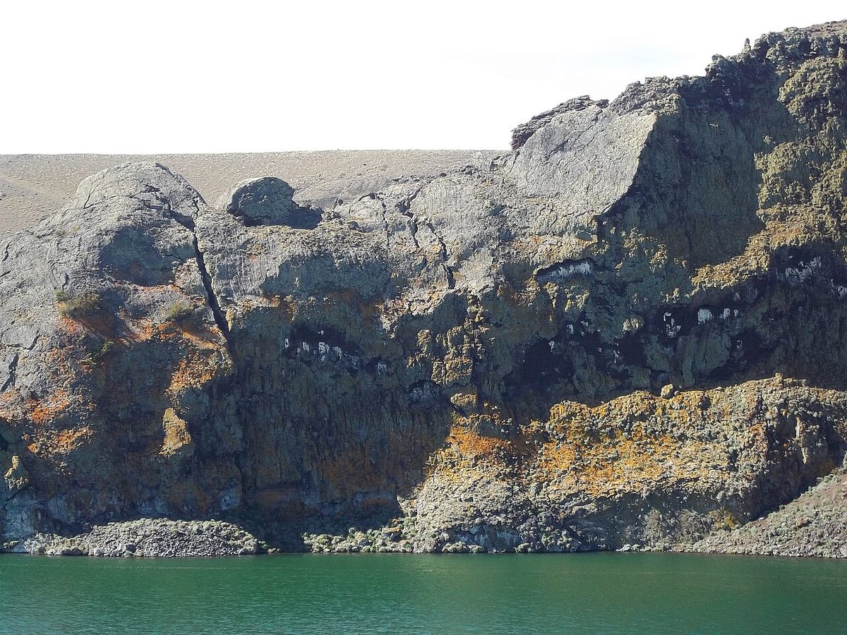 A cliff above a glacial lake in Argentine Patagonia, the kind of exposed ground where wind gusts decide the day