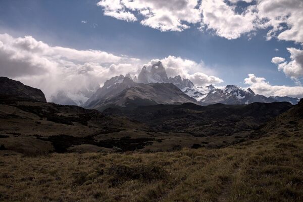 Cloud lifting off the Fitz Roy massif above the dark steppe near El Chaltén