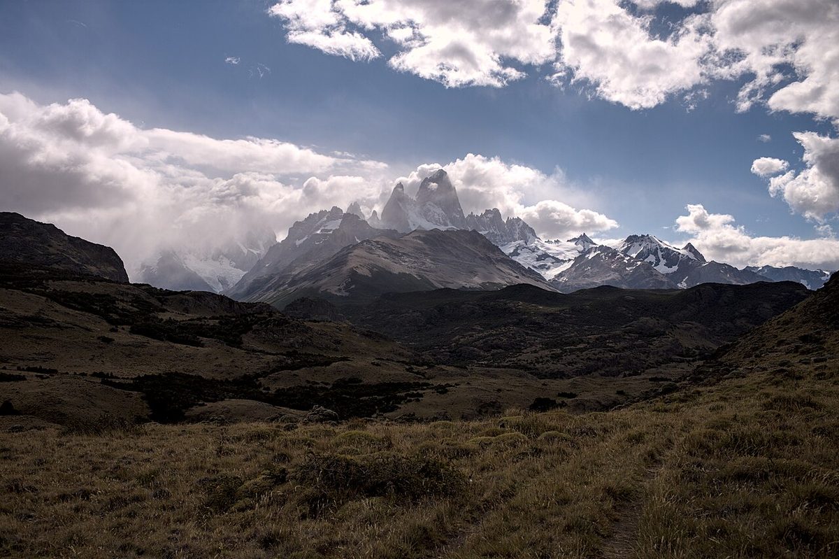 Cloud lifting off the Fitz Roy massif above the dark steppe near El Chaltén