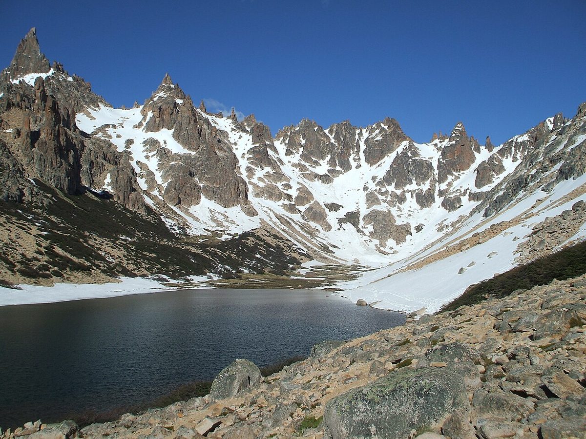 Laguna Toncek below the granite spires of Cerro Catedral, the lake beside Refugio Frey near Bariloche