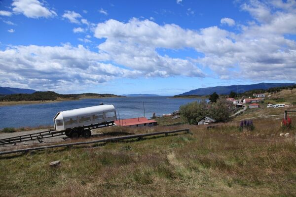 The white-walled farmhouse and outbuildings of Estancia Harberton on the Beagle Channel shore in Tierra del Fuego, founded in 1886