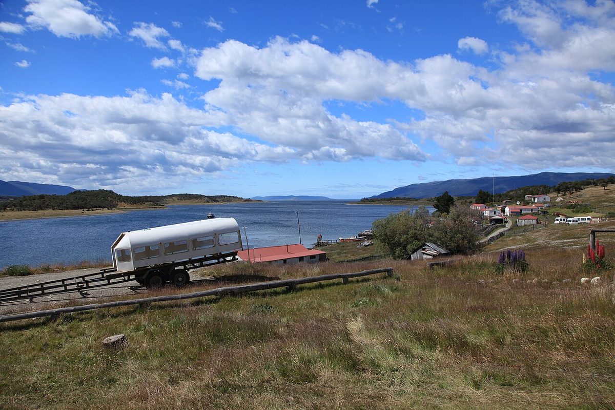 The white-walled farmhouse and outbuildings of Estancia Harberton on the Beagle Channel shore in Tierra del Fuego, founded in 1886