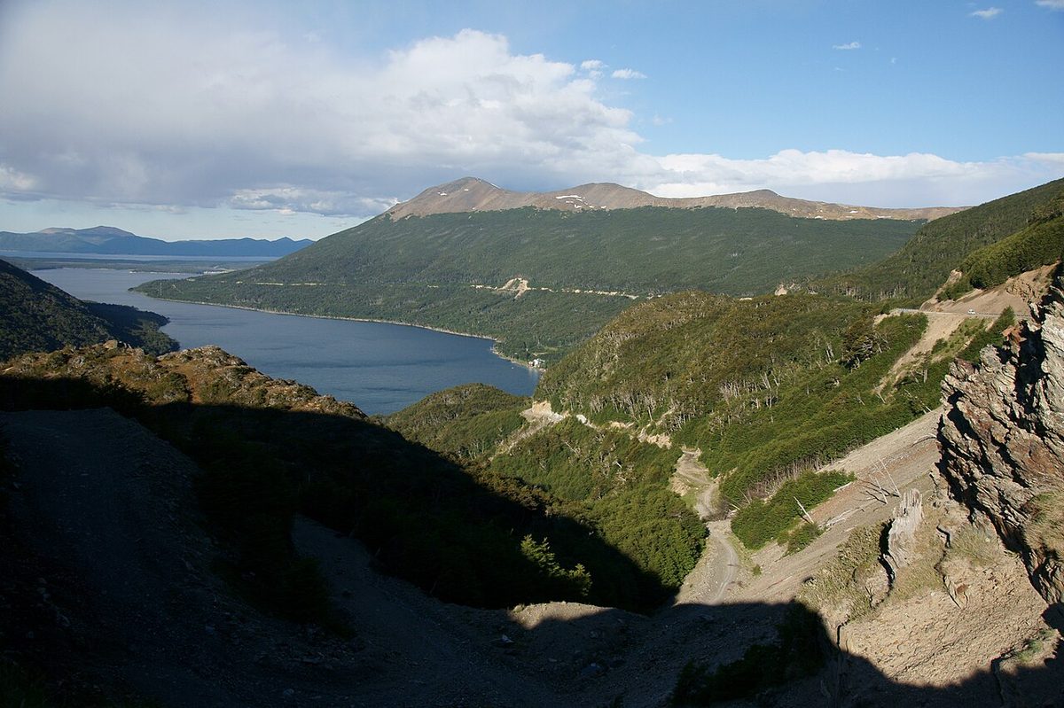 The road winding through the forested valley below Paso Garibaldi, with Lago Escondido in Tierra del Fuego beyond